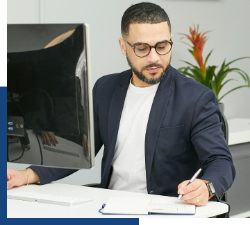 IT professional at desk working with computer systems